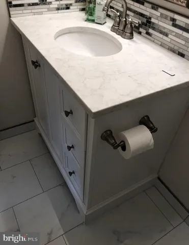 a bathroom with a sink and vanity