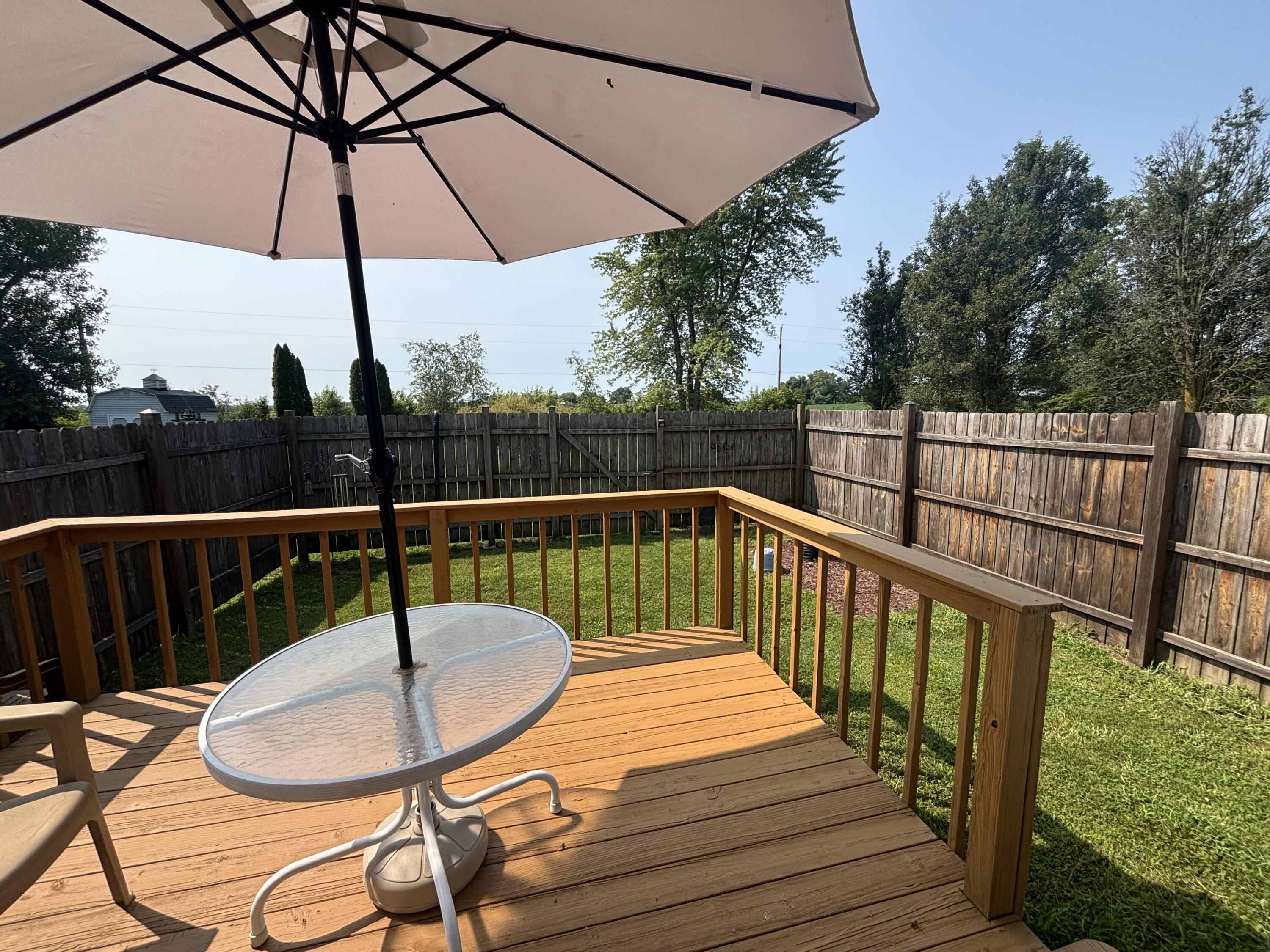 8193 Oak Tree Drive Rensselaer, IN 47978 - Photo 20 of 29 a balcony with wooden floor and outdoor seating
