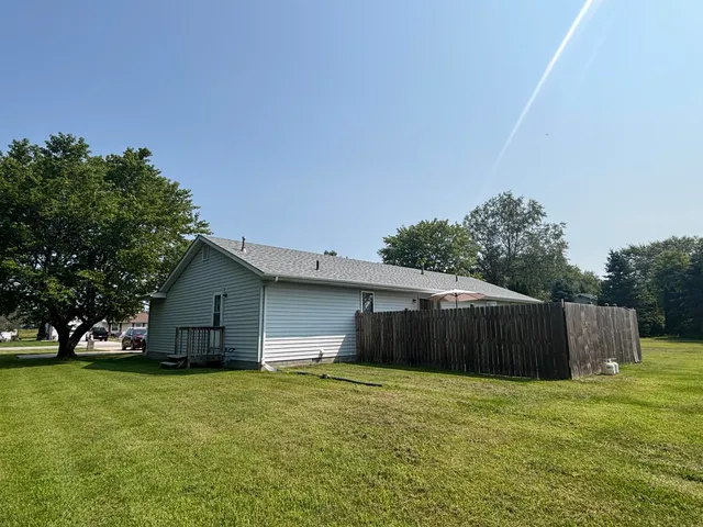 a view of a field of grass and trees