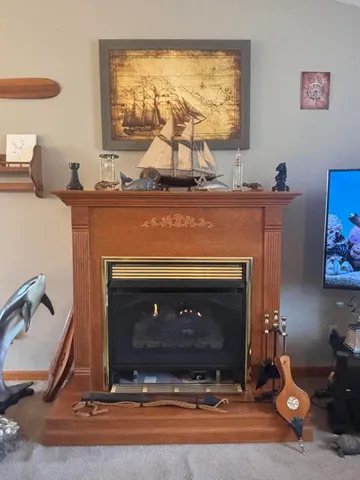 a living room with furniture fireplace and a window