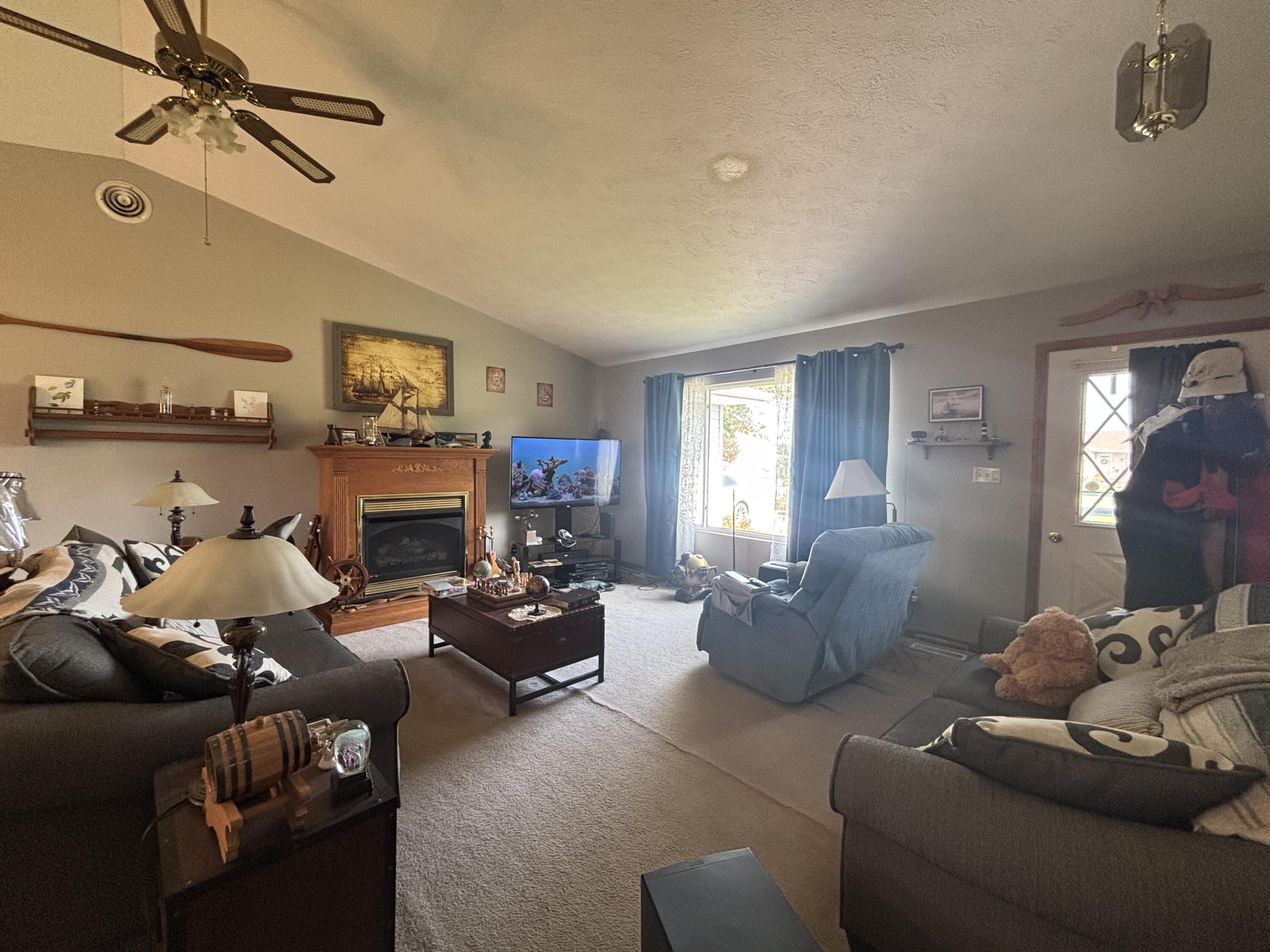 8193 Oak Tree Drive Rensselaer, IN 47978 - Photo 6 of 29 a living room with furniture fireplace and a window