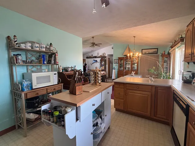 a dining room with furniture a chandelier and wooden floor
