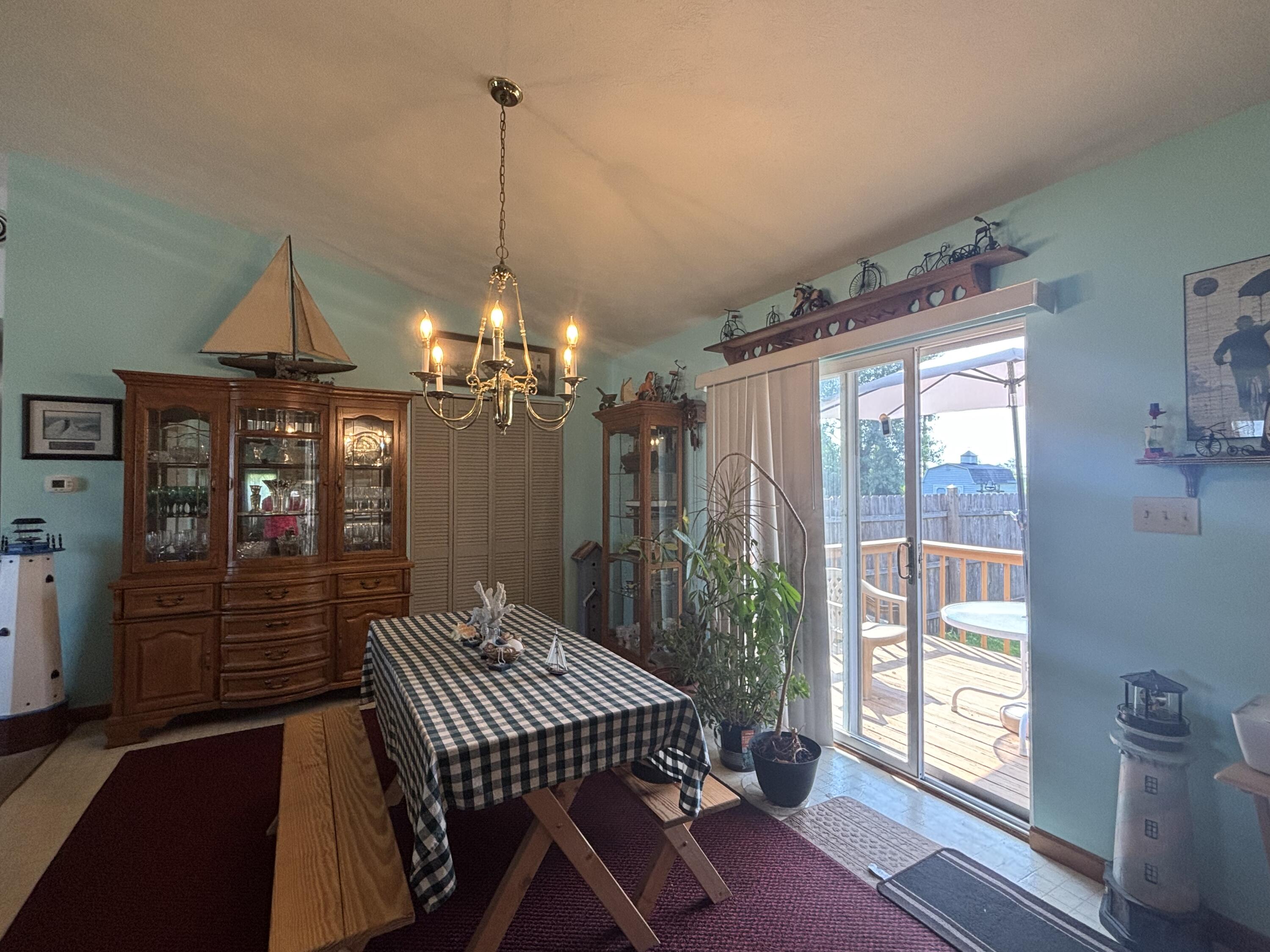 8193 Oak Tree Drive Rensselaer, IN 47978 - Photo 9 of 29 a dining room with furniture a chandelier and wooden floor