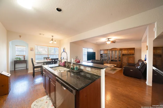 a kitchen with sink refrigerator and cabinets