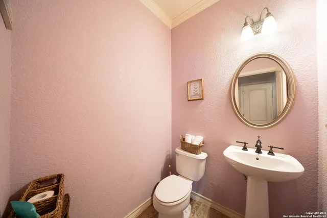 a bathroom with a toilet a sink and a mirror