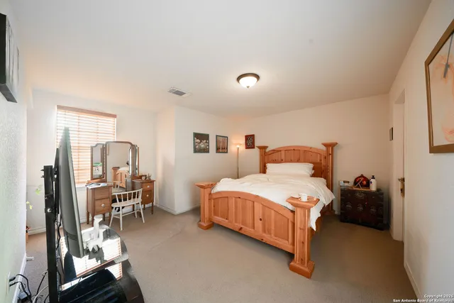 a bedroom with a bed and large windows