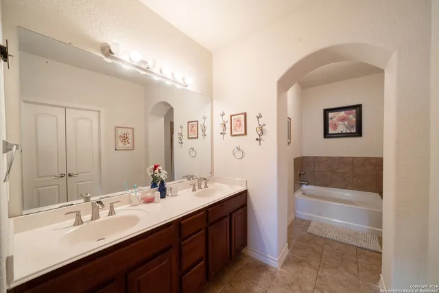 a bathroom with a double vanity sink a mirror and a