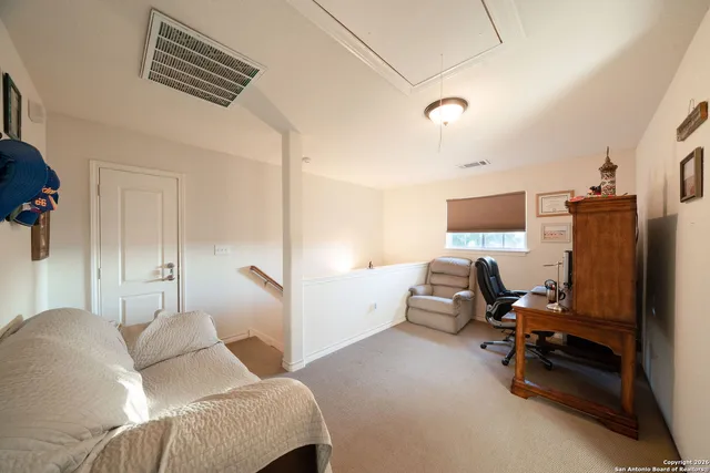 a bedroom with furniture and a flat screen tv