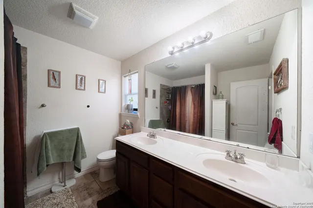 a bathroom with a sink double vanity and a mirror