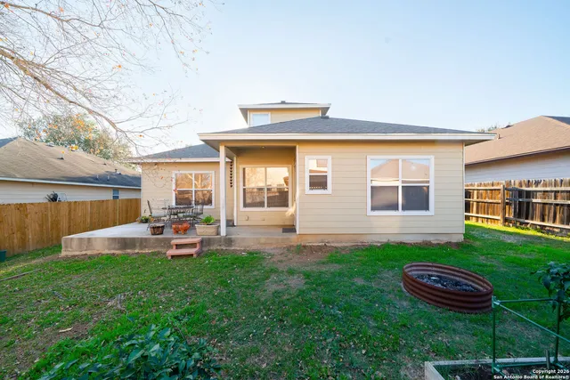 a front view of a house with a yard and outdoor seating