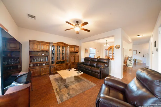a living room with furniture ceiling fan and a rug