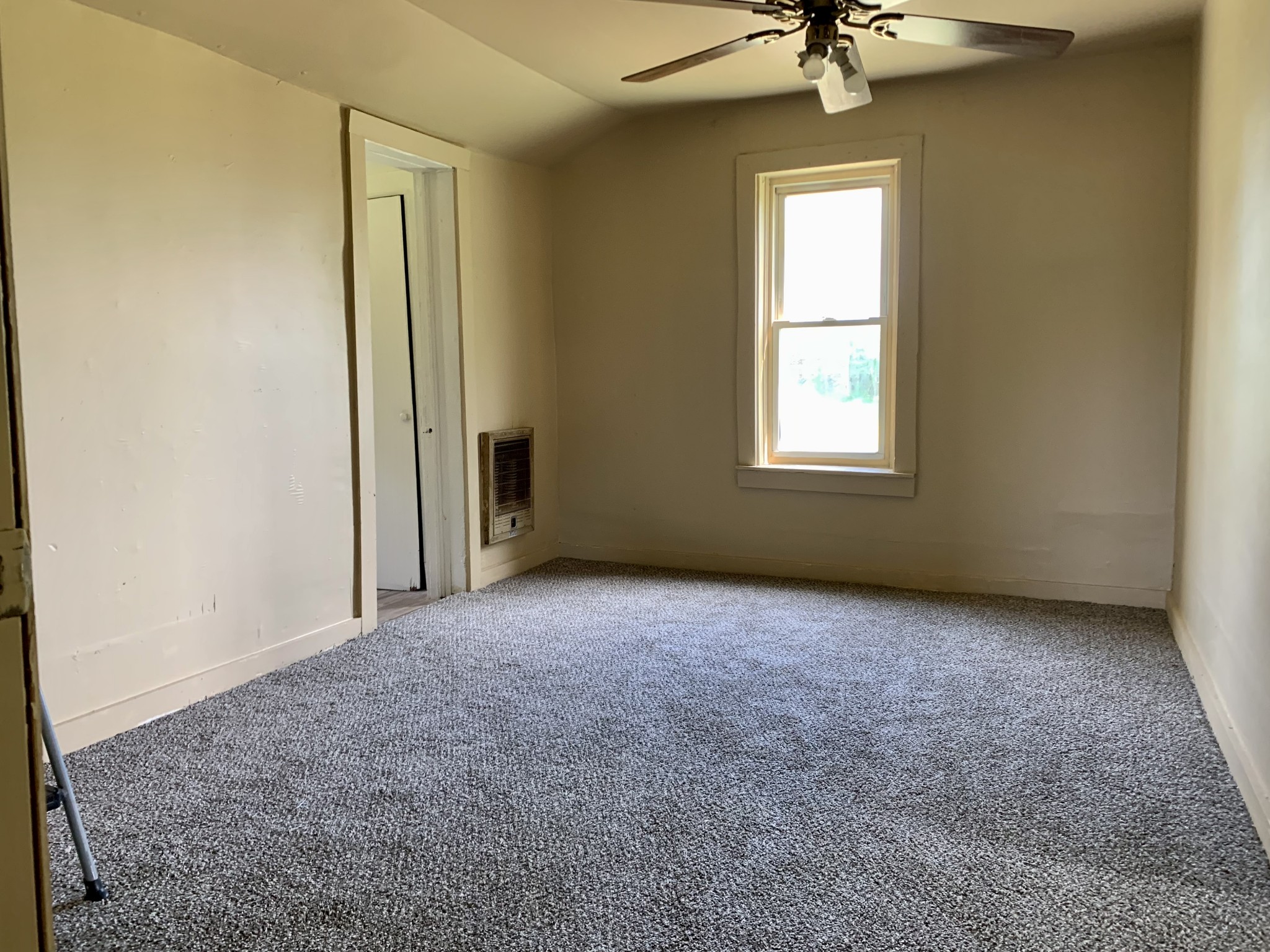 5580 Galen Road Lafayette, TN 37083 - Photo 4 of 16 an empty room with a chandelier fan and windows