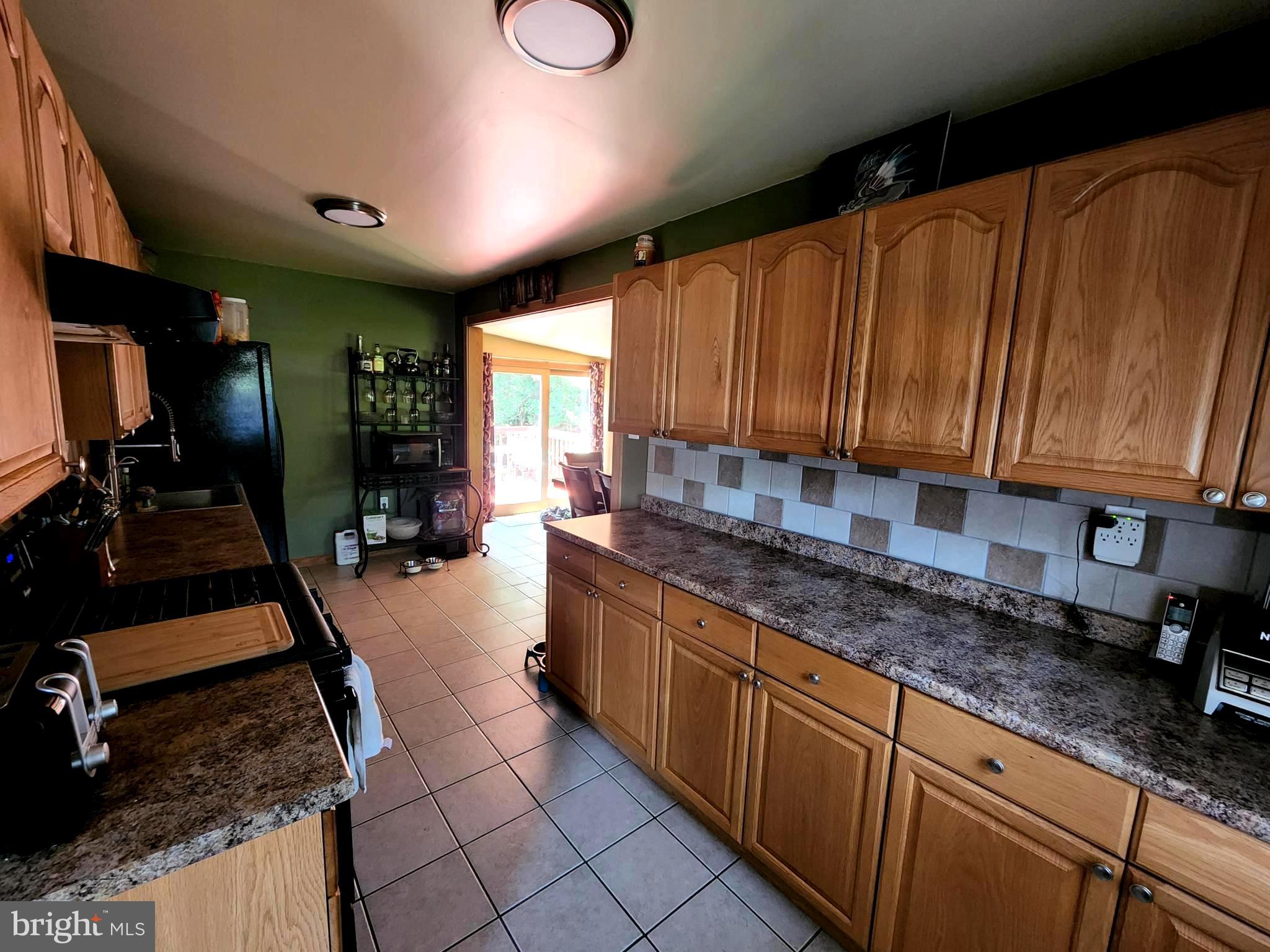 27 Mackeys Lane Leesburg, NJ 08327 - Photo 15 of 29 a kitchen with sink a refrigerator and cabinets