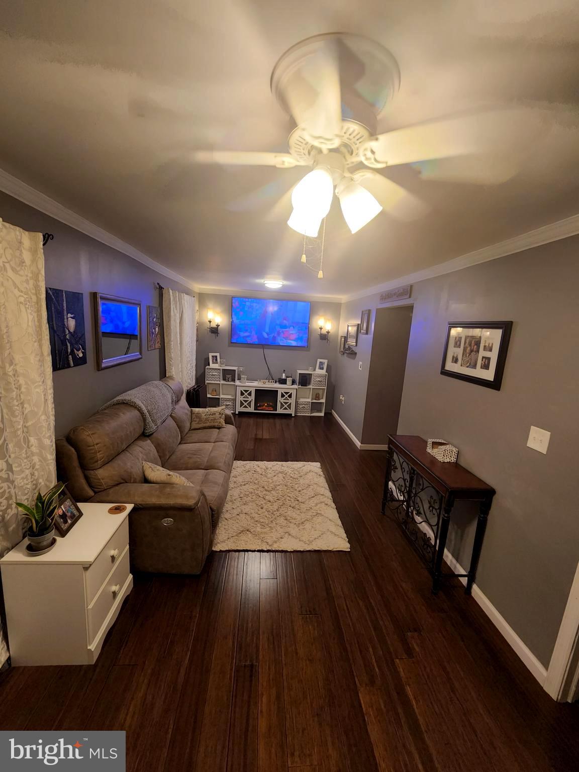 27 Mackeys Lane Leesburg, NJ 08327 - Photo 17 of 29 a living room with furniture and a chandelier