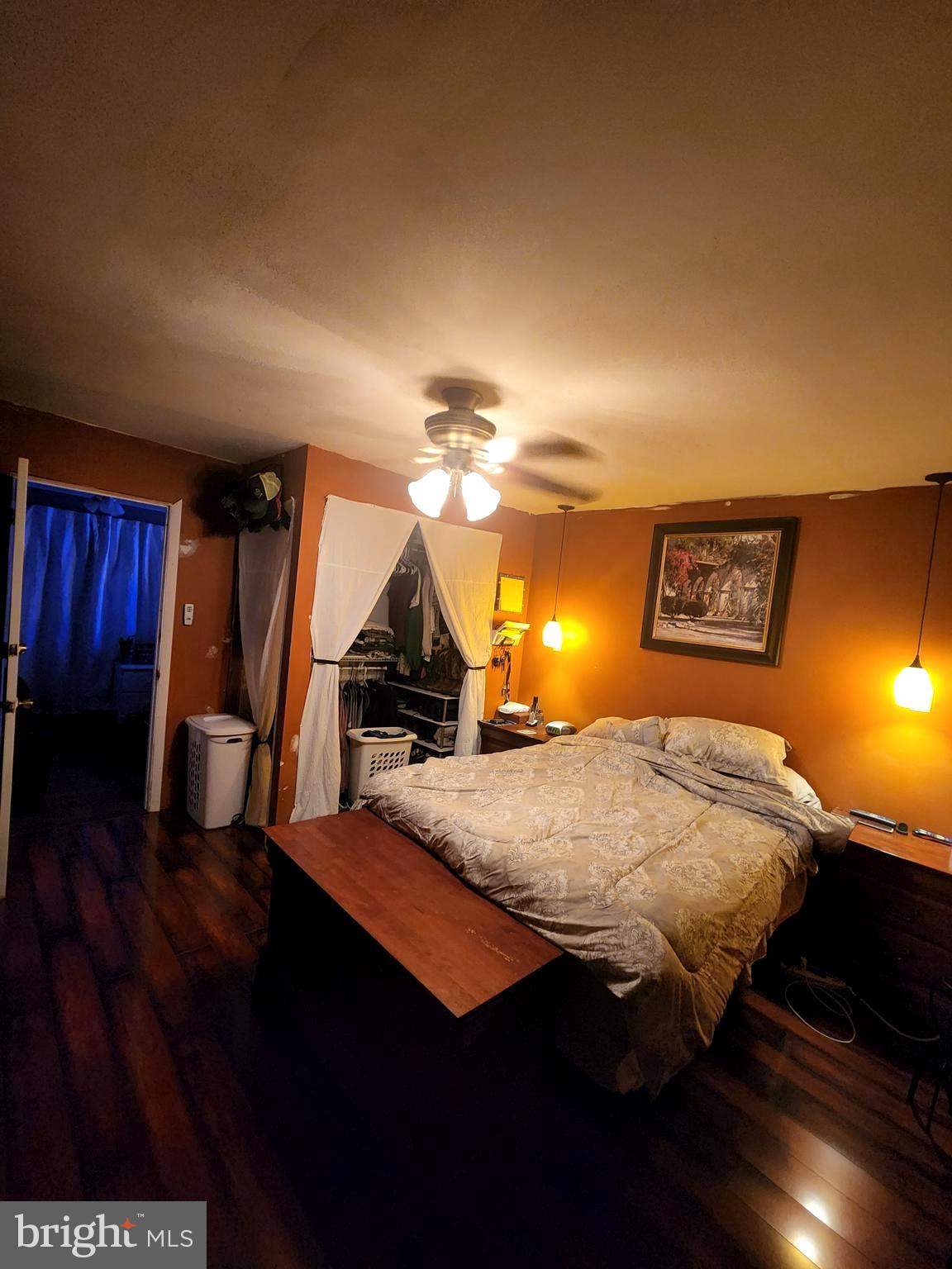 27 Mackeys Lane Leesburg, NJ 08327 - Photo 22 of 29 a bedroom with a bed and wooden floor