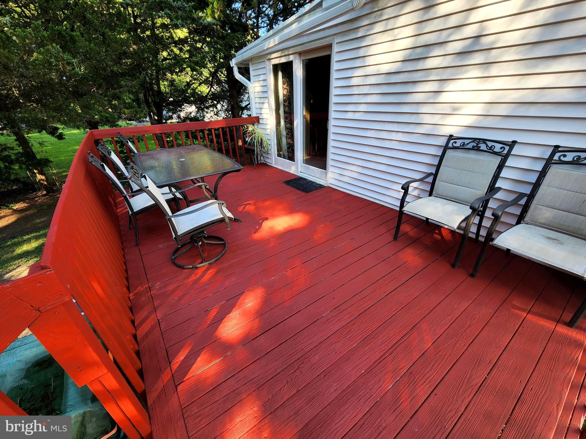 27 Mackeys Lane Leesburg, NJ 08327 - Photo 4 of 29 a roof deck with table and chairs and wooden floor