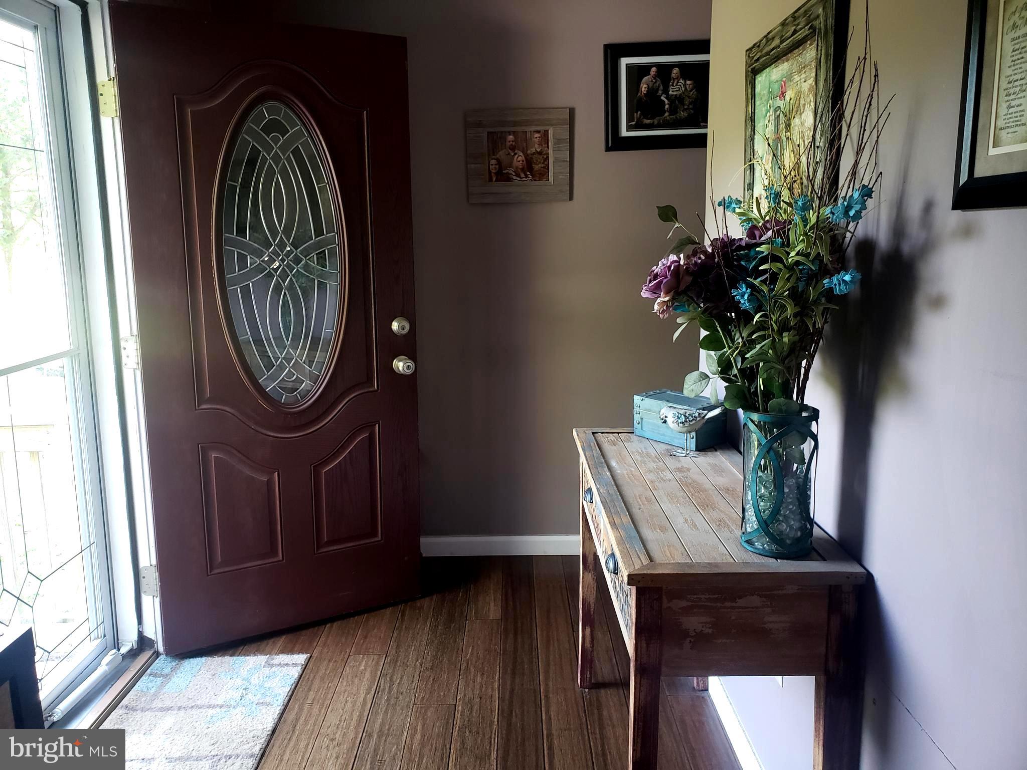 27 Mackeys Lane Leesburg, NJ 08327 - Photo 9 of 29 a view of a hallway with wooden floor and a mirror