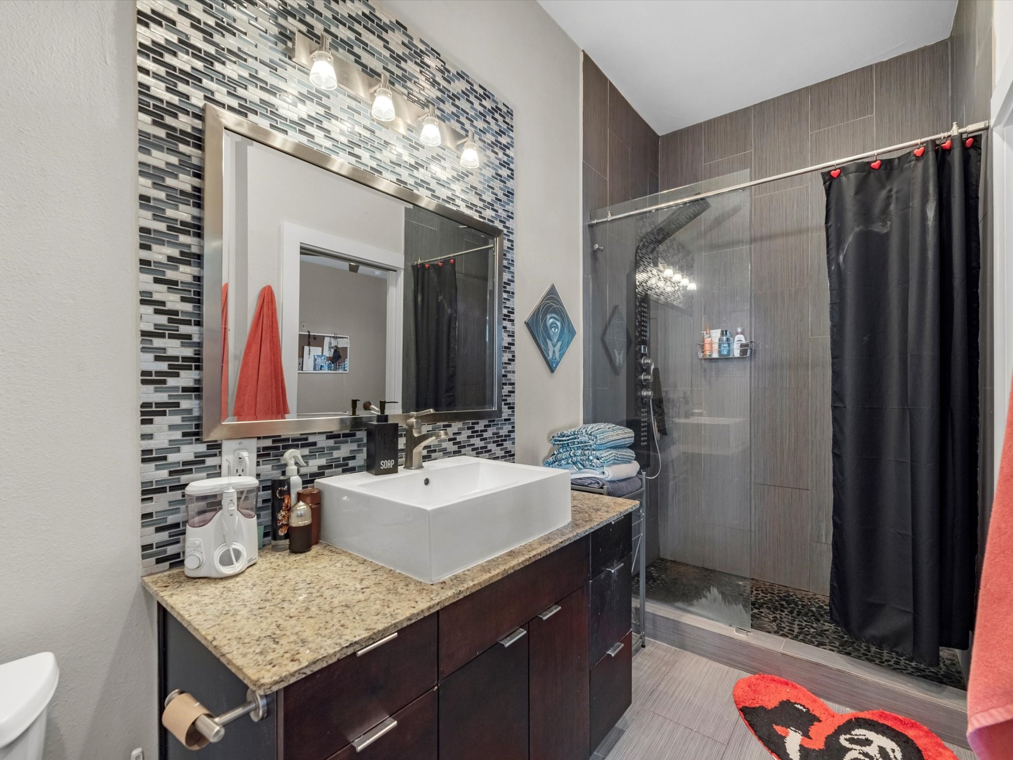 1406 Columbus Street, Unit 303 Houston, TX 77019 - Photo 12 of 17 a bathroom with a granite countertop sink and a mirror