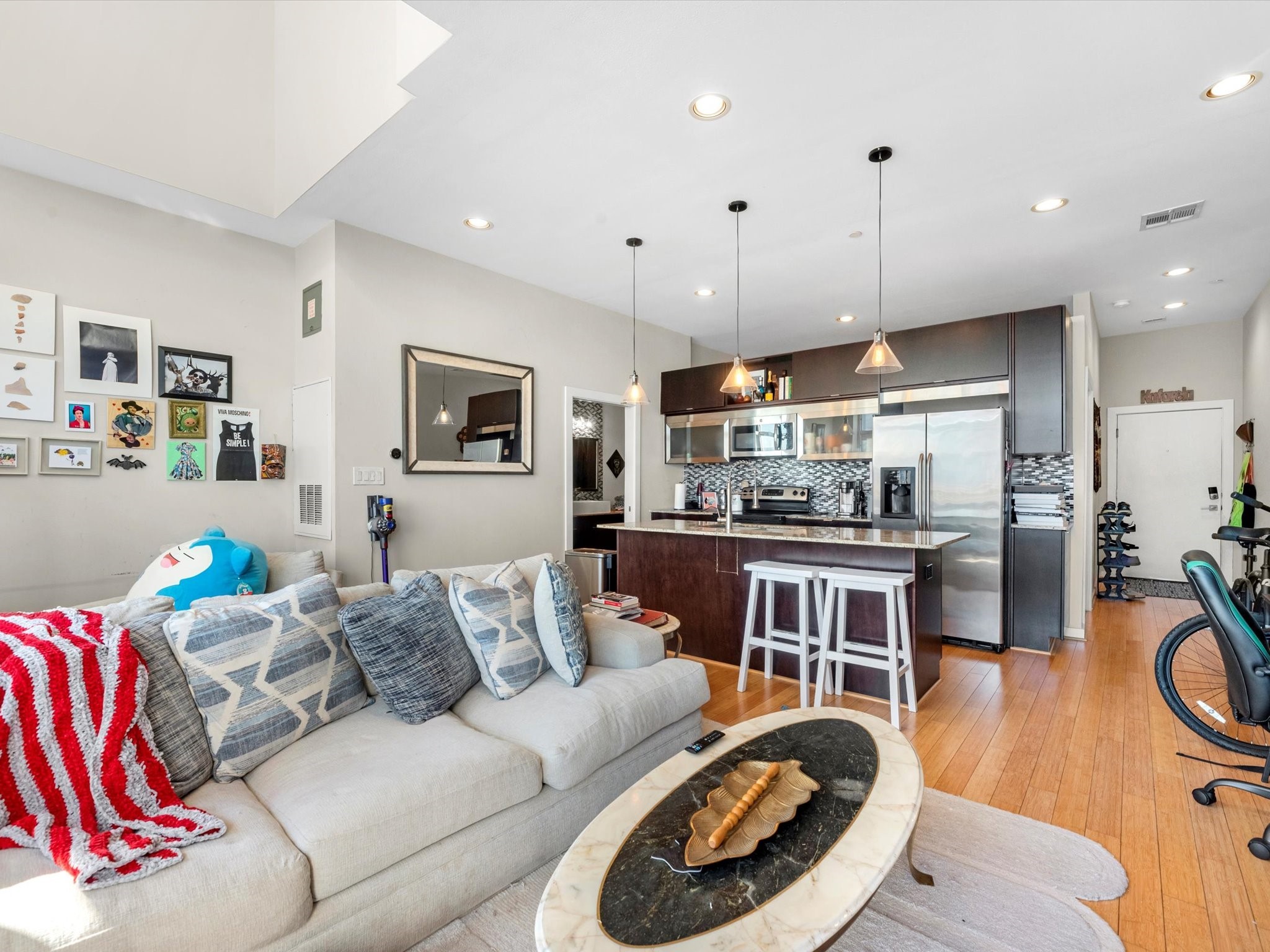 1406 Columbus Street, Unit 303 Houston, TX 77019 - Photo 6 of 17 a living room with furniture kitchen view and a wooden floor