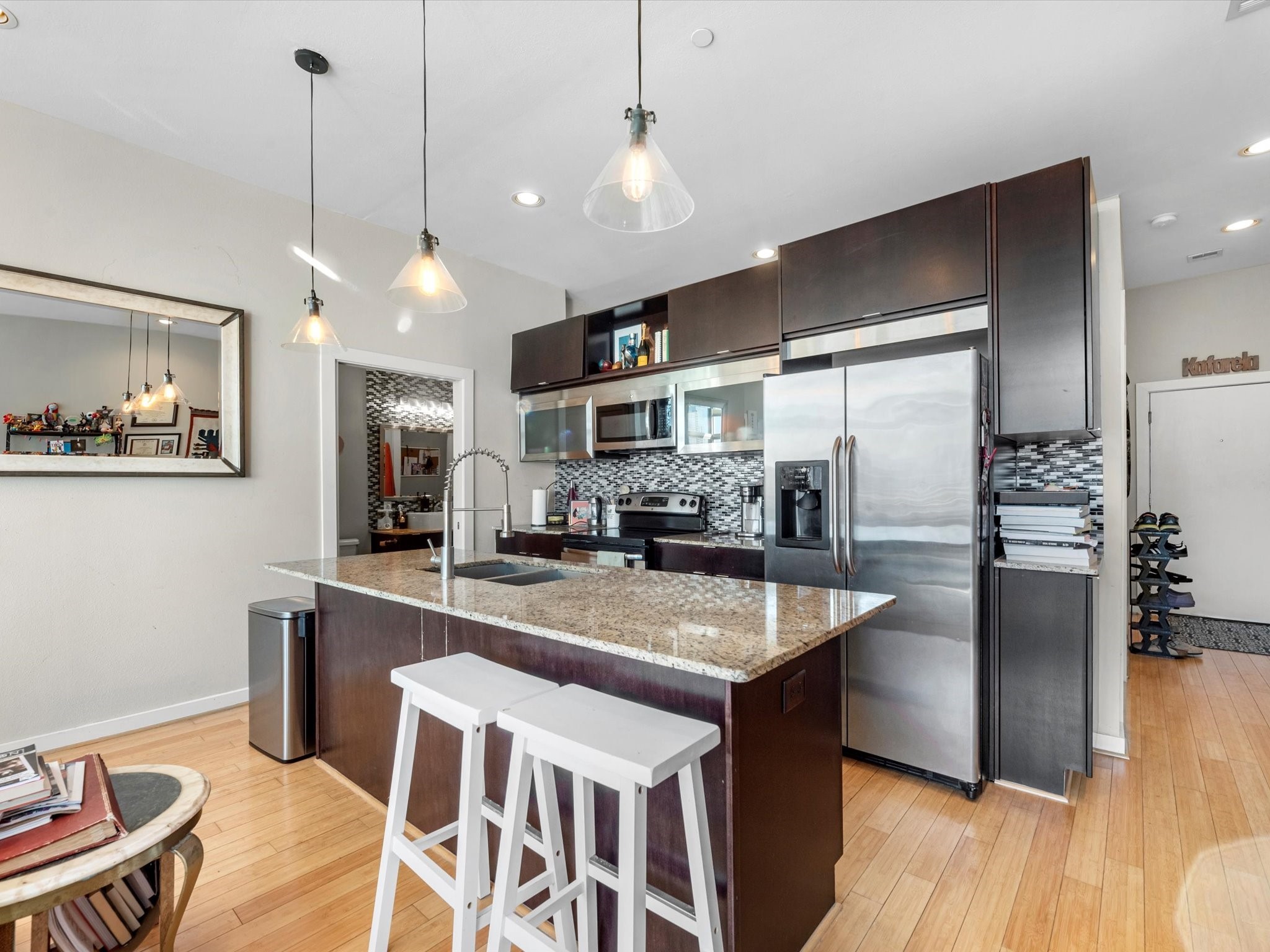 1406 Columbus Street, Unit 303 Houston, TX 77019 - Photo 7 of 17 a kitchen with stainless steel appliances granite countertop a sink a stove and a refrigerator