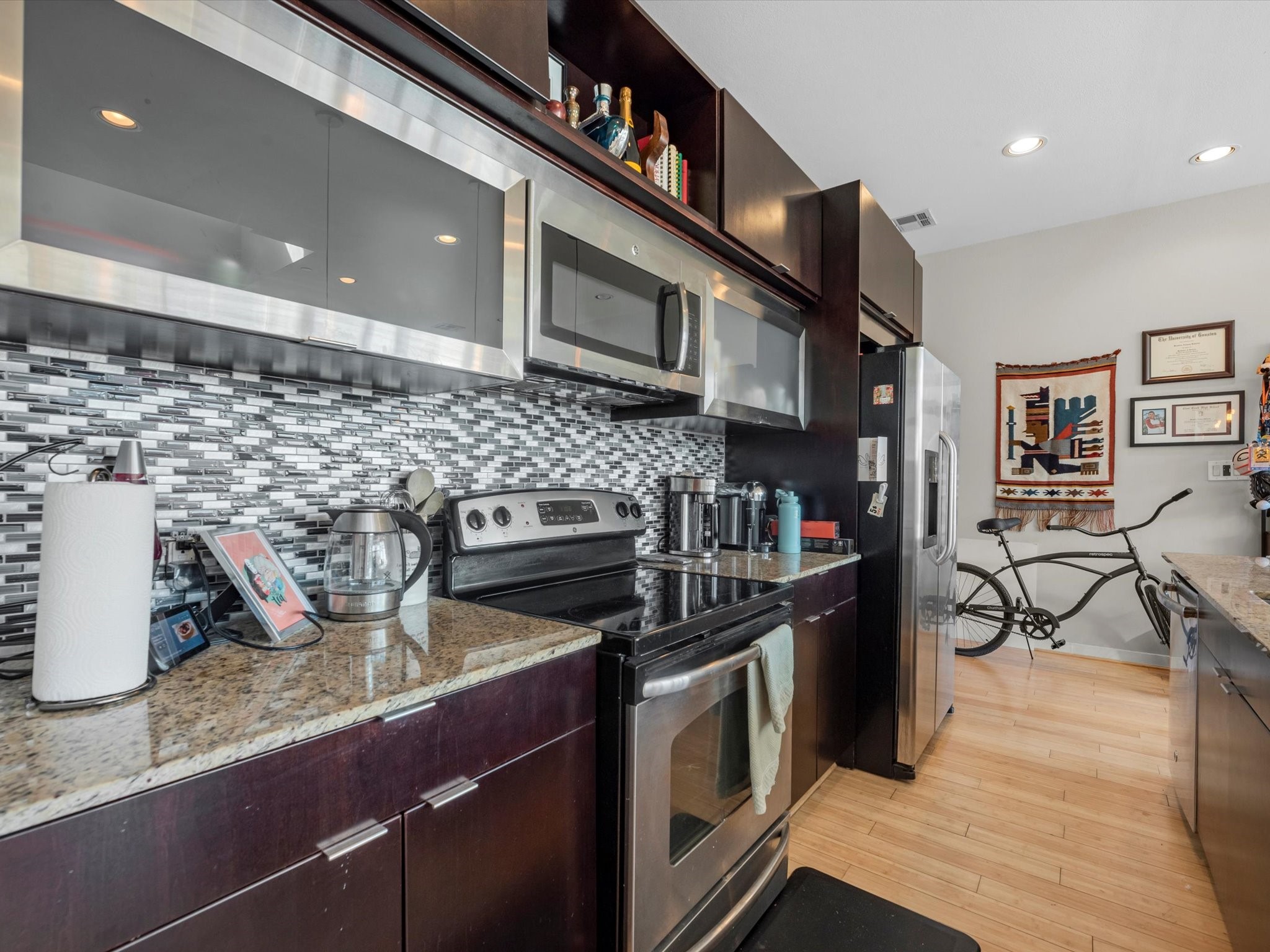 1406 Columbus Street, Unit 303 Houston, TX 77019 - Photo 8 of 17 a kitchen with stainless steel appliances granite countertop a stove a sink and a refrigerator