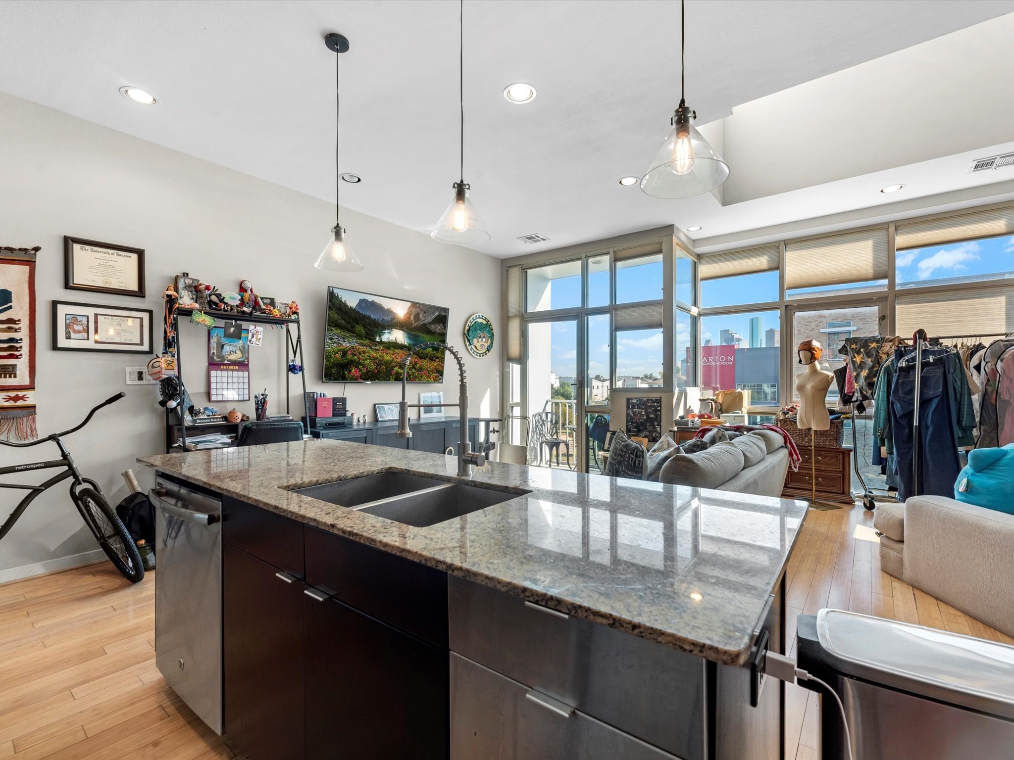 1406 Columbus Street, Unit 303 Houston, TX 77019 - Photo 9 of 17 a kitchen with stainless steel appliances granite countertop a sink a center island and furniture