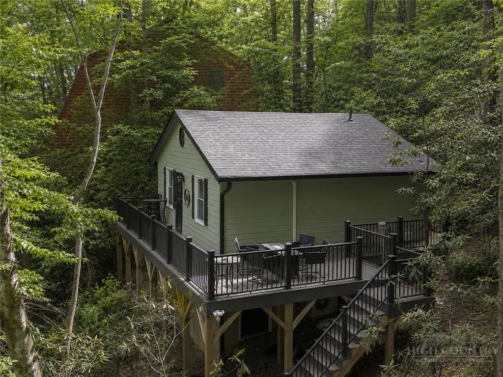 141 Snowflake Road Banner Elk, NC 28604 - Photo 1 of 28 a view of house with table and chairs in the patio