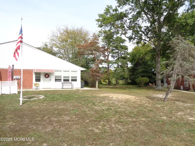 a backyard of a house with large trees