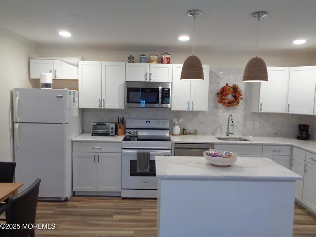 a kitchen with a sink a stove and refrigerator