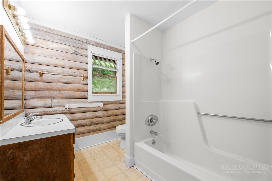 233 Alpine Acres Road Vilas, NC 28692 - Photo 18 of 32 a bathroom with a sink and a bathtub