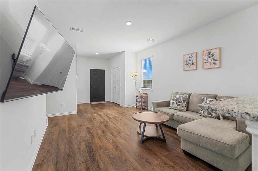 401 Thompson Place Everman, TX 76140 - Photo 11 of 23 a living room with furniture and a wooden floor