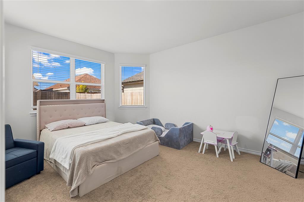 401 Thompson Place Everman, TX 76140 - Photo 12 of 23 a bedroom with a bed and a window