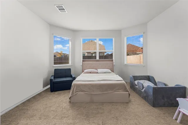 a spacious bedroom with a bed and window