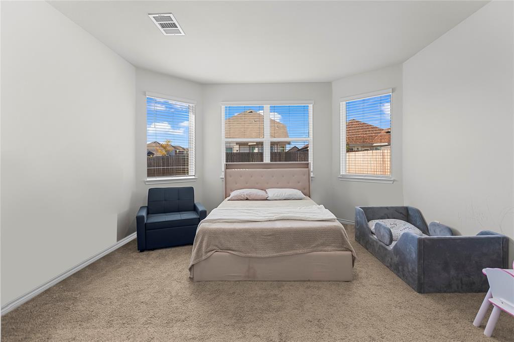 401 Thompson Place Everman, TX 76140 - Photo 13 of 23 a spacious bedroom with a bed and window