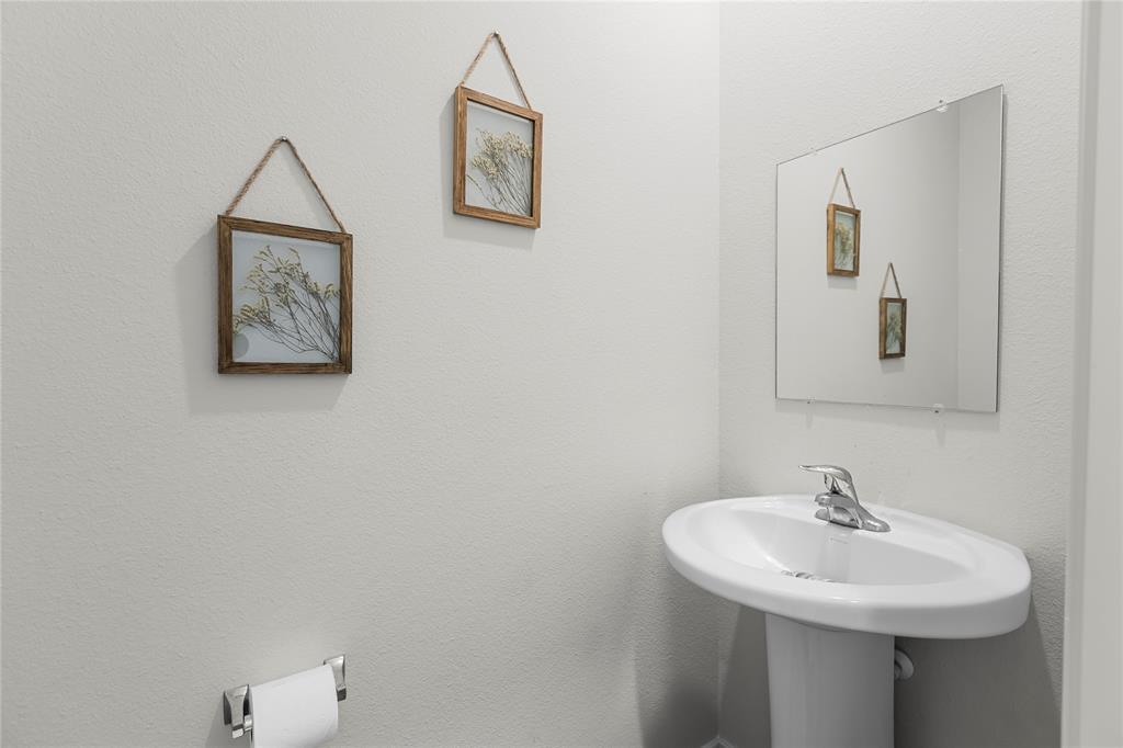 401 Thompson Place Everman, TX 76140 - Photo 15 of 23 a bathroom with a sink and a mirror