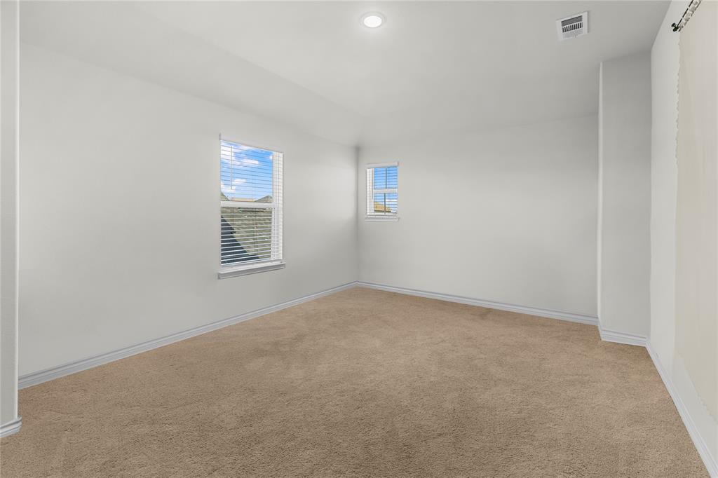 401 Thompson Place Everman, TX 76140 - Photo 17 of 23 an empty room with windows