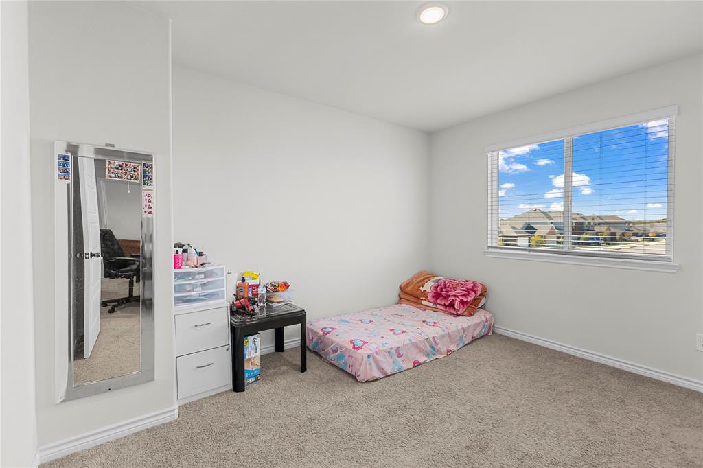 401 Thompson Place Everman, TX 76140 - Photo 19 of 23 a bedroom with a bed and a window