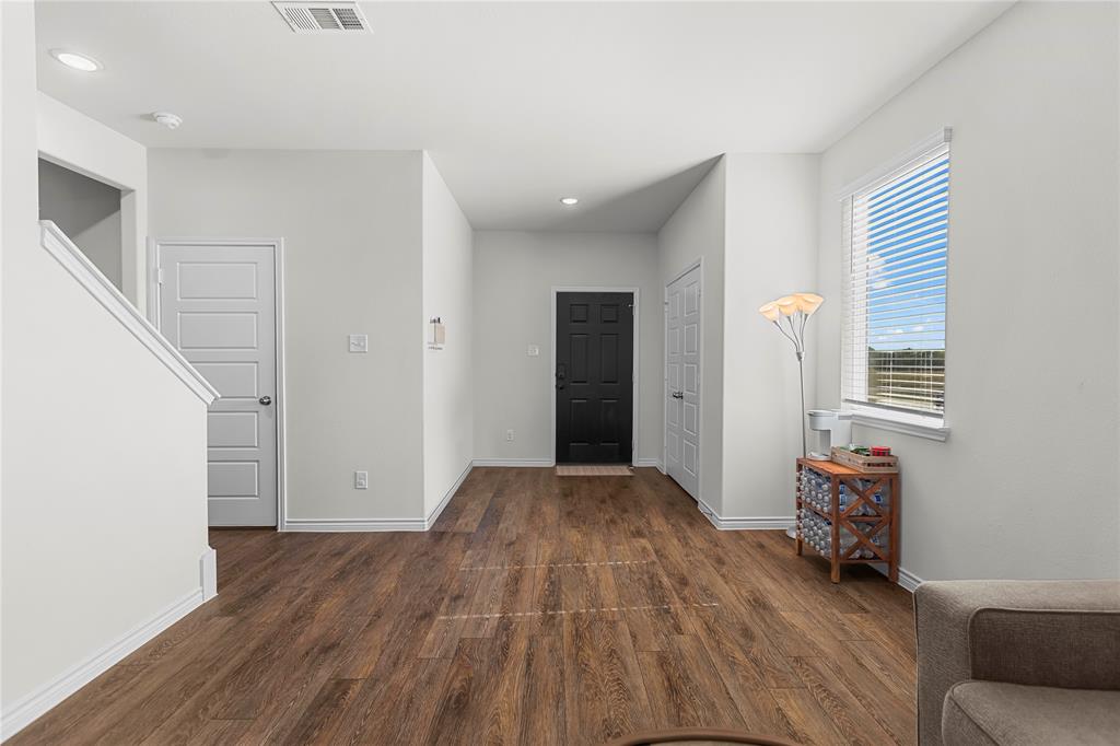 401 Thompson Place Everman, TX 76140 - Photo 4 of 23 a view of room with wooden floor and furniture