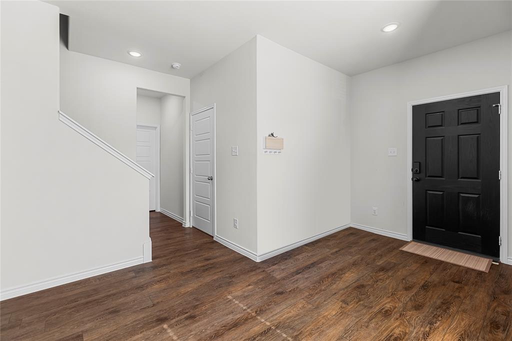401 Thompson Place Everman, TX 76140 - Photo 5 of 23 a view of an empty room with wooden floor
