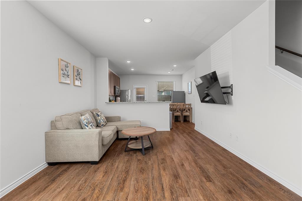 401 Thompson Place Everman, TX 76140 - Photo 6 of 23 a living room with furniture and a flat screen tv