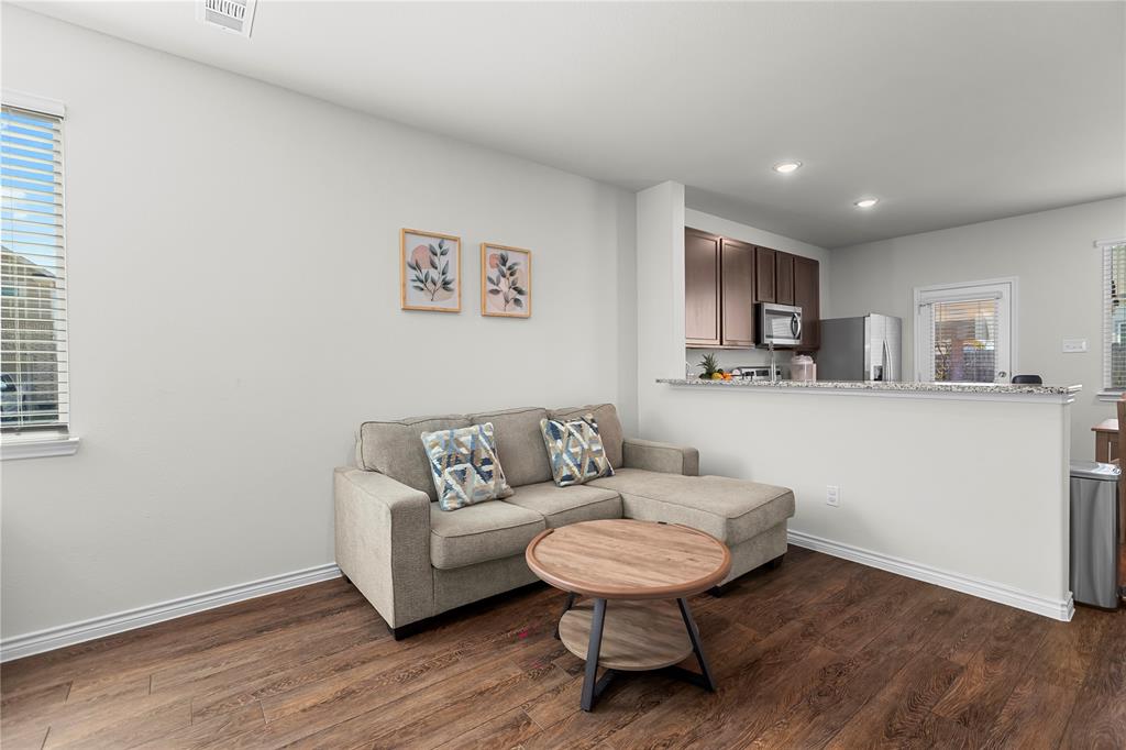 401 Thompson Place Everman, TX 76140 - Photo 7 of 23 a living room with a couch and a view of kitchen