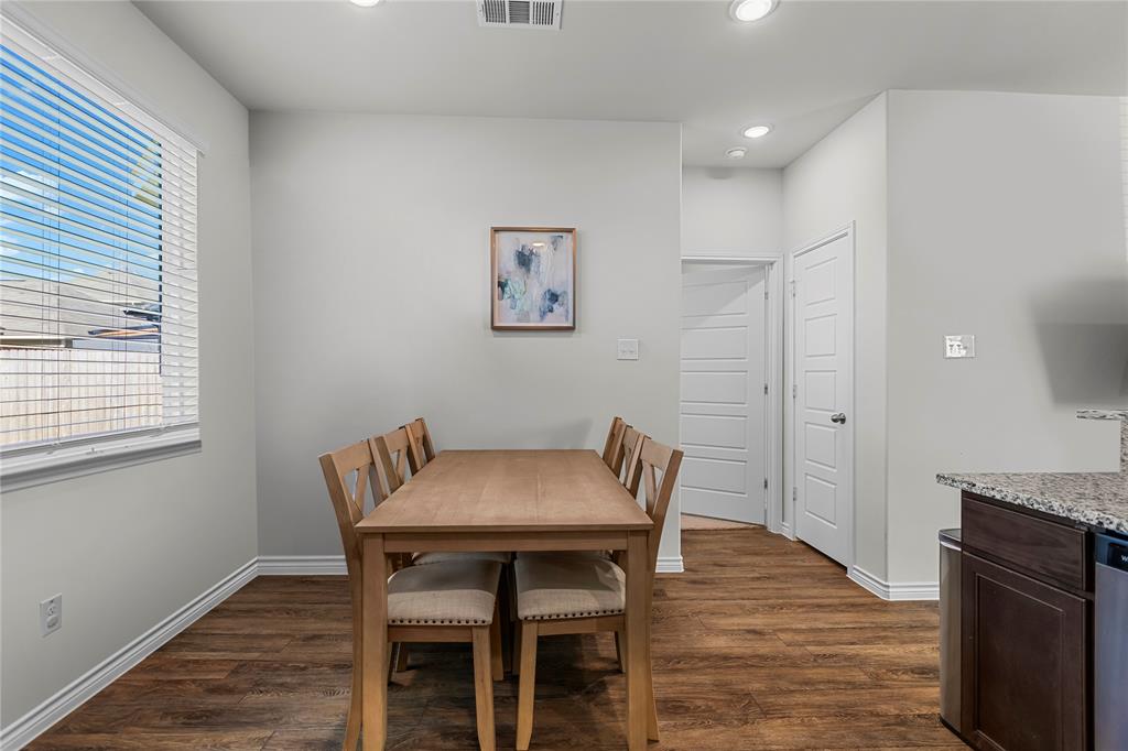 401 Thompson Place Everman, TX 76140 - Photo 9 of 23 a view of a dining room with furniture and wooden floor