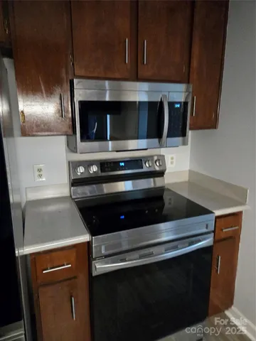 a kitchen with a sink a stove and cabinets