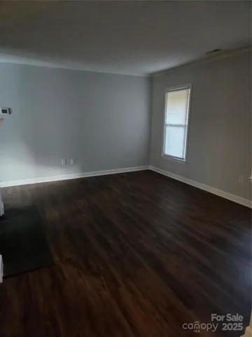 a view of wooden floor and windows in a room