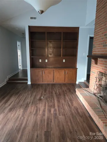 a view of a room with wooden floor
