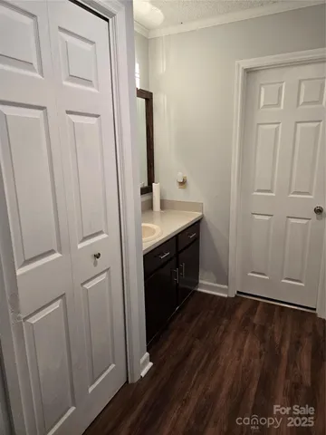 a view of bathroom with a sink mirror and window