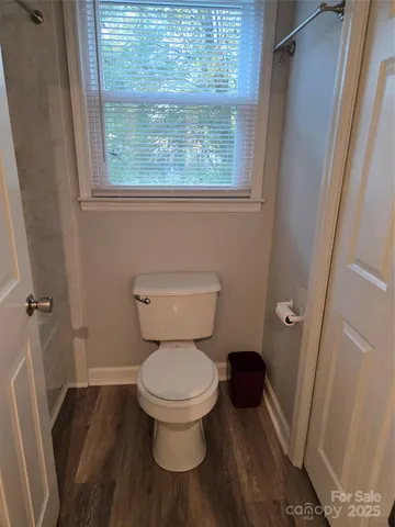 a white toilet sitting next to a window