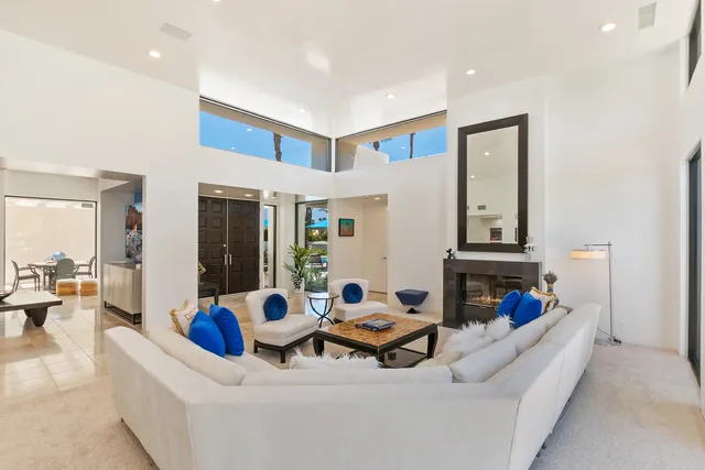 a outdoor space with lots of tables a garden view and a fireplace