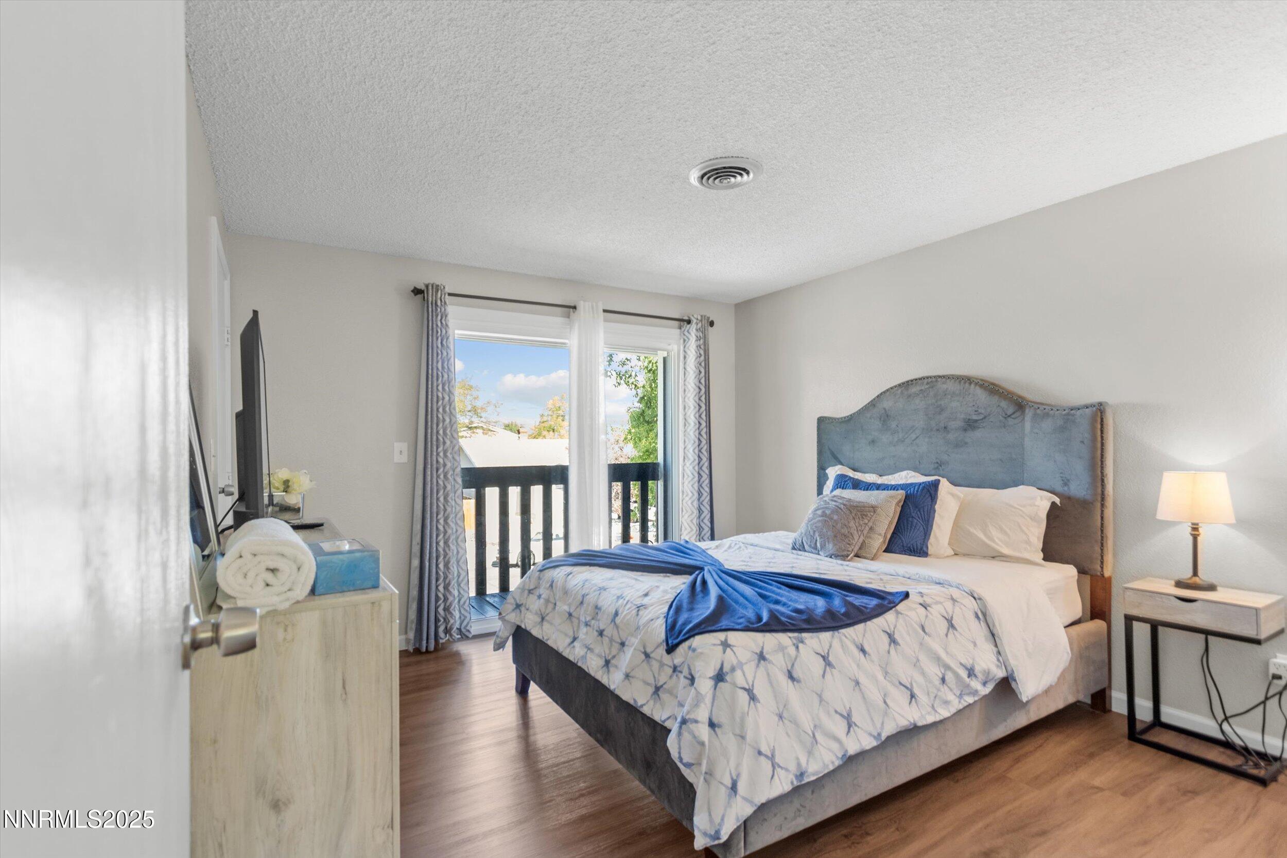 400 Claremont Street Reno, NV 89502 - Photo 14 of 32 a bedroom with a bed and wooden floor
