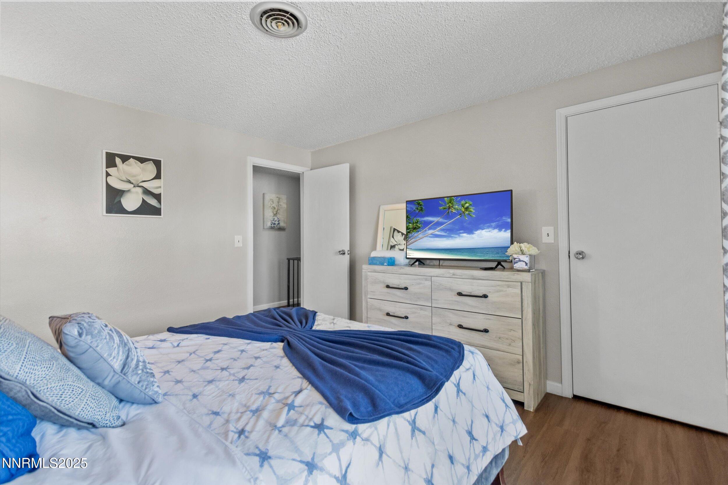 400 Claremont Street Reno, NV 89502 - Photo 15 of 32 a bedroom with a bed and a flat screen tv